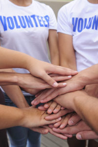 Volunteer group putting hands together