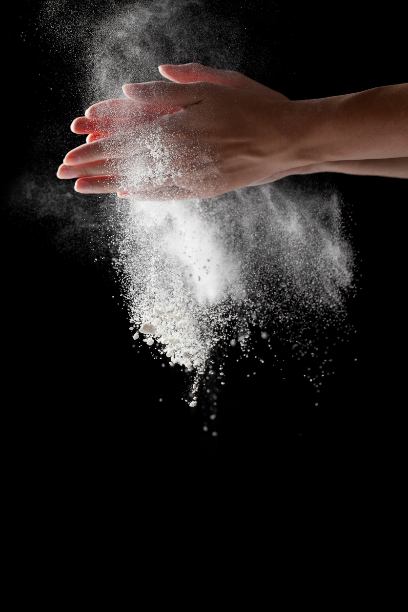 woman coating her hands in powder chalk magnesium GymnasticsNZ